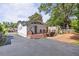 Back exterior view of home with a wood deck, stone steps, and a paved driveway leading to the street at 1039 Ridgecrest Se Dr, Smyrna, GA 30080