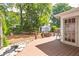 This wood deck has access to the home and provides a peaceful view of the lush backyard landscape at 1039 Ridgecrest Se Dr, Smyrna, GA 30080
