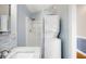 Bathroom featuring tile backsplash, standing shower, and stacked washer and dryer at 1039 Ridgecrest Se Dr, Smyrna, GA 30080