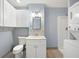 Bathroom featuring gray tiling, standing shower, stacked washer and dryer, and vanity at 1039 Ridgecrest Se Dr, Smyrna, GA 30080