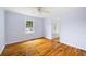 Light-filled bedroom features hardwood floors, neutral paint, and a ceiling fan at 1039 Ridgecrest Se Dr, Smyrna, GA 30080