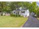 Charming front exterior with manicured lawn, inviting entry, and a long driveway to the detached garage at 1039 Ridgecrest Se Dr, Smyrna, GA 30080