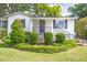 Well maintained front yard featuring landscaped bushes, green grass, and dark shutters on the windows at 1039 Ridgecrest Se Dr, Smyrna, GA 30080