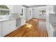 Bright kitchen with hardwood floors, white cabinets, and stainless steel sink at 1039 Ridgecrest Se Dr, Smyrna, GA 30080