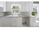 Kitchen featuring granite counters, stainless steel sink, and white cabinets at 1039 Ridgecrest Se Dr, Smyrna, GA 30080