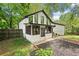 Exterior view of home with large backyard, mature trees, and screened-in porch at 104 River Creek Dr, Woodstock, GA 30188