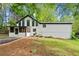 Exterior view of home with large backyard, mature trees, and screened-in porch at 104 River Creek Dr, Woodstock, GA 30188