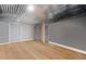 Unfinished basement with light wood floors, corrugated metal ceiling, and neutral painted walls at 104 River Creek Dr, Woodstock, GA 30188