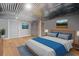 Staged basement with light wood floors, corrugated metal ceiling, and stylish decor at 104 River Creek Dr, Woodstock, GA 30188