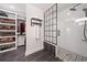 Modern bathroom featuring tiled walk-in shower with black framed glass enclosure and custom shelving at 104 River Creek Dr, Woodstock, GA 30188