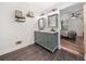 Modern bathroom featuring double sink vanity with decorative wall shelves and an adjoining bedroom with ceiling fan at 104 River Creek Dr, Woodstock, GA 30188