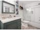 Stylish bathroom featuring a blue vanity with unique carved detail, quartz countertop, and subway tiled shower at 104 River Creek Dr, Woodstock, GA 30188