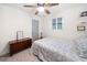 Comfortable bedroom with natural light, ceiling fan, and simple furnishings for relaxation at 104 River Creek Dr, Woodstock, GA 30188