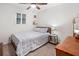 Comfortable bedroom with natural light, ceiling fan, and simple furnishings for relaxation at 104 River Creek Dr, Woodstock, GA 30188