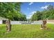 An entrance sign for Little River Crossing is framed by lush greenery and a grassy landscape at 104 River Creek Dr, Woodstock, GA 30188