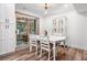 Inviting dining area with white table and chairs, elegant lighting, and access to outdoor area at 104 River Creek Dr, Woodstock, GA 30188