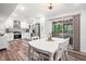 Open concept dining and kitchen area features modern appliances and access to outdoor space at 104 River Creek Dr, Woodstock, GA 30188