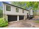 Two-car garage with stone accent and updated exterior; inviting curb appeal at 104 River Creek Dr, Woodstock, GA 30188