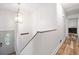 Well-lit hallway with hardwood floors, leading to various rooms in the home at 104 River Creek Dr, Woodstock, GA 30188