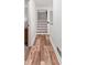 Hallway featuring hardwood style floors, staircase, and access to other rooms at 104 River Creek Dr, Woodstock, GA 30188