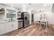 Bright kitchen features stainless steel refrigerator and adjacent eating area with natural light at 104 River Creek Dr, Woodstock, GA 30188