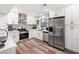 Modern kitchen boasts stainless steel appliances, white cabinetry, and a stylish backsplash at 104 River Creek Dr, Woodstock, GA 30188