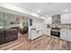 Open-concept kitchen and living area with stainless steel appliances and a cozy fireplace at 104 River Creek Dr, Woodstock, GA 30188