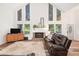 Bright living room with a cozy fireplace, large windows, and comfortable seating at 104 River Creek Dr, Woodstock, GA 30188