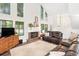 Cozy living room showcasing a fireplace and large windows for plenty of natural light at 104 River Creek Dr, Woodstock, GA 30188