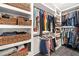 Spacious walk-in closet with custom built-in shelving and organizers for clothing and accessories at 104 River Creek Dr, Woodstock, GA 30188