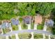An aerial view showing the rooftops of attractive suburban homes, manicured lawns, and lush trees at 1045 Legacy Walk, Woodstock, GA 30189