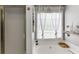 Bright bathroom featuring a soaking tub with natural light and neutral décor at 1045 Legacy Walk, Woodstock, GA 30189