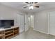 Bedroom featuring neutral colors, ceiling fan, large closet, and plush carpet at 1045 Legacy Walk, Woodstock, GA 30189