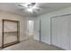 Bedroom featuring plush carpet, ceiling fan, and large closet at 1045 Legacy Walk, Woodstock, GA 30189