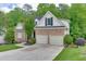Charming home with stone facade, attached two-car garage, and well-manicured lawn at 1045 Legacy Walk, Woodstock, GA 30189