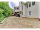 Back exterior with a screened porch and level yard at 1045 Legacy Walk, Woodstock, GA 30189