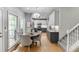 Eat-in kitchen with a chandelier, stainless steel appliances, and two-tone cabinets at 1045 Legacy Walk, Woodstock, GA 30189