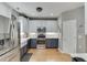 A stainless steel refrigerator and oven are visible in this kitchen, featuring tile backsplash at 1045 Legacy Walk, Woodstock, GA 30189