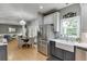 Open kitchen featuring stainless steel appliances, two-tone cabinets, and hardwood floors at 1045 Legacy Walk, Woodstock, GA 30189