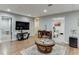 Finished basement living area with wood floors, a large television, and neutral paint at 1045 Legacy Walk, Woodstock, GA 30189