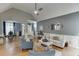 Bright living room with vaulted ceiling and fireplace; open floor plan to dining room and kitchen at 1045 Legacy Walk, Woodstock, GA 30189