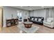 Finished basement living area with wood floors, comfortable seating, and neutral paint at 1045 Legacy Walk, Woodstock, GA 30189