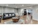 Finished basement living area with wood floors, comfortable seating, and access to an office space at 1045 Legacy Walk, Woodstock, GA 30189