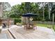Outdoor wooden deck with furniture, lounge chairs, a dining table, and a blue umbrella perfect for relaxing at 515 Houze Way, Roswell, GA 30076