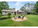 Spacious backyard featuring a stone firepit area with seating, well-manicured lawn and patio area, great for entertaining at 515 Houze Way, Roswell, GA 30076