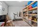 Unfinished basement space with storage shelves and carpet, perfect for storage or customization at 515 Houze Way, Roswell, GA 30076