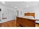 Another spacious bedroom featuring hardwood floors, a decorative bed frame, and ample natural light at 515 Houze Way, Roswell, GA 30076