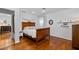 Spacious bedroom featuring hardwood floors, a decorative bed frame, and ample natural light at 515 Houze Way, Roswell, GA 30076