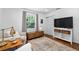 Bright bedroom features a large window, a side table, and neutral decor at 515 Houze Way, Roswell, GA 30076