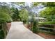 Long driveway leads to the home, surrounded by mature trees and landscaping at 515 Houze Way, Roswell, GA 30076